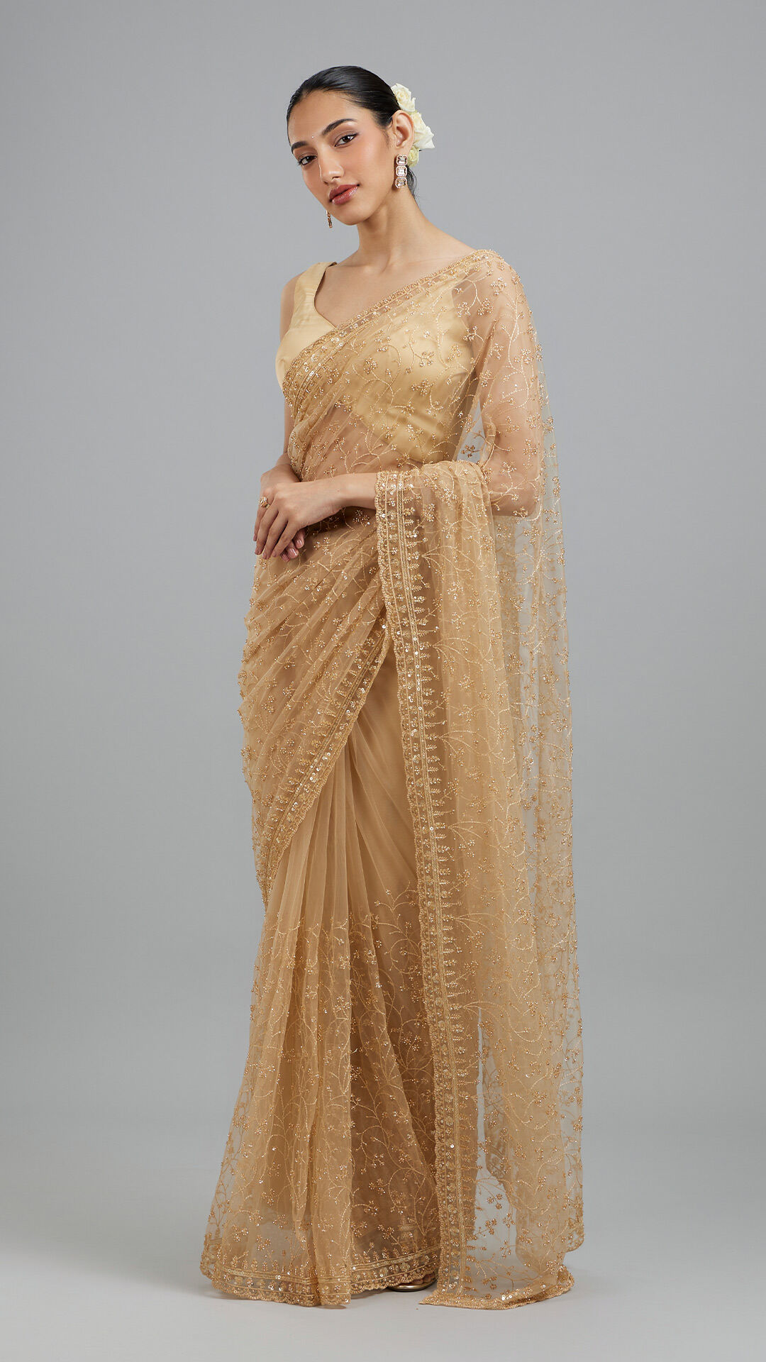 Woman flaunting her elegant golden beige saree